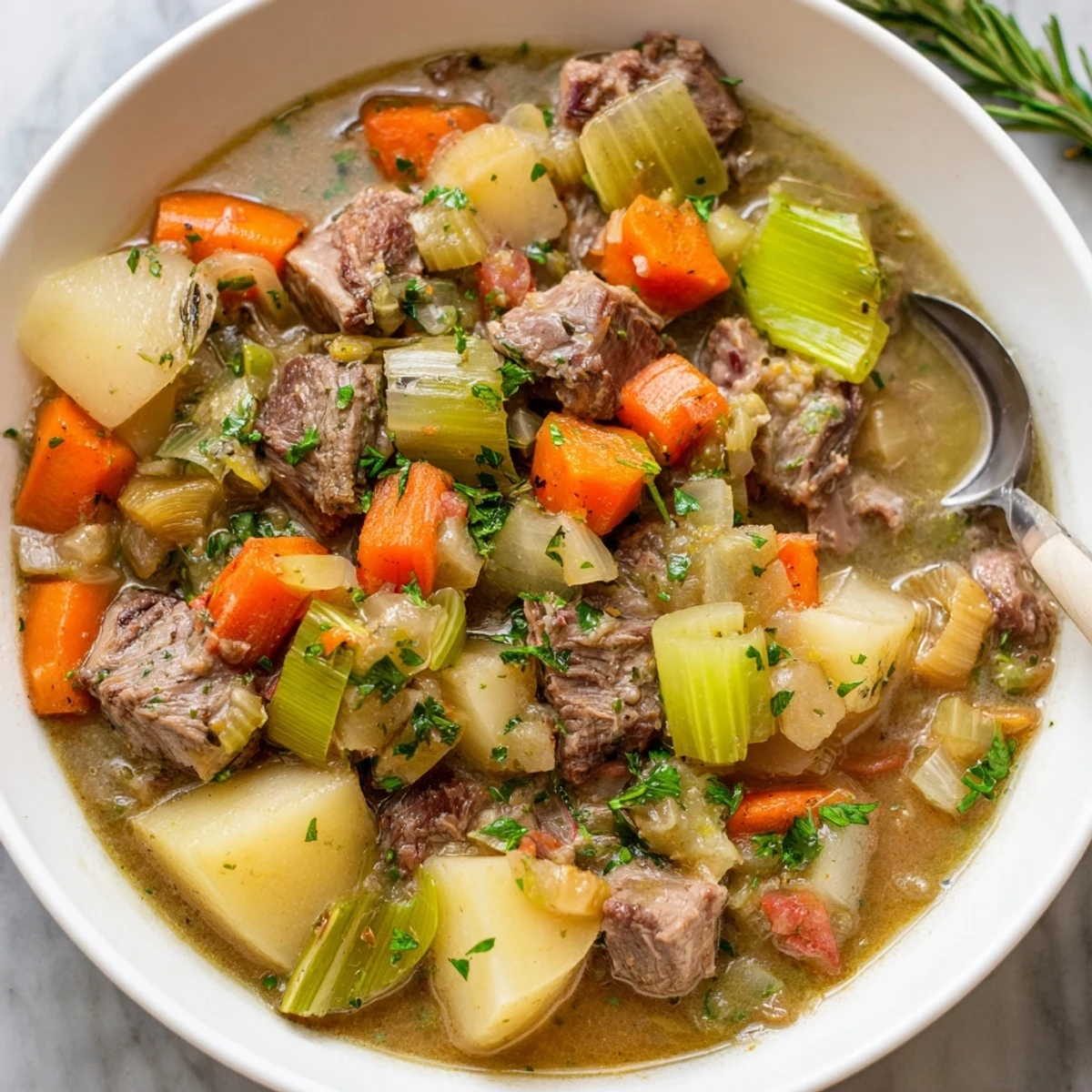 Rich, savory slow cooker herb lamb stew served with crusty gluten-free bread.  