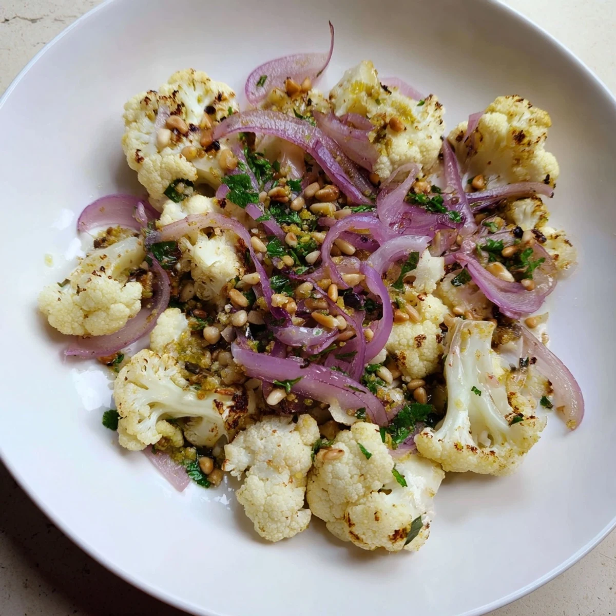 Warm Roasted Cauliflower Salad with vibrant roasted cauliflower florets and a bright lemon pine-nut dressing.