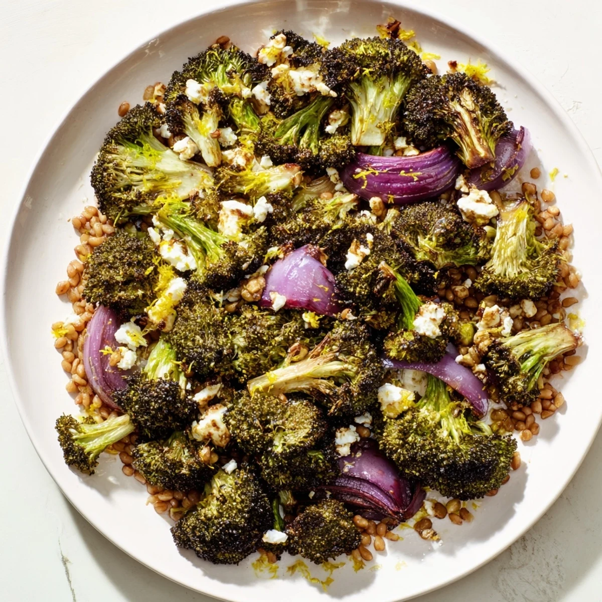 Warm roasted broccoli with a garlic-lemon dressing topping farro, a Mediterranean-inspired dish.