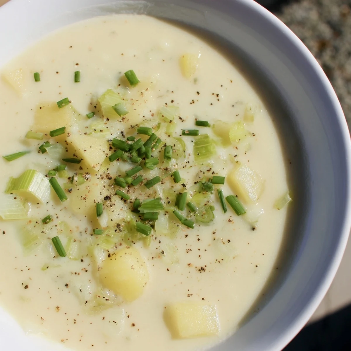 Creamy textured Potato Leek Soup, perfect for dipping crusty bread, ready to serve on a cold day.