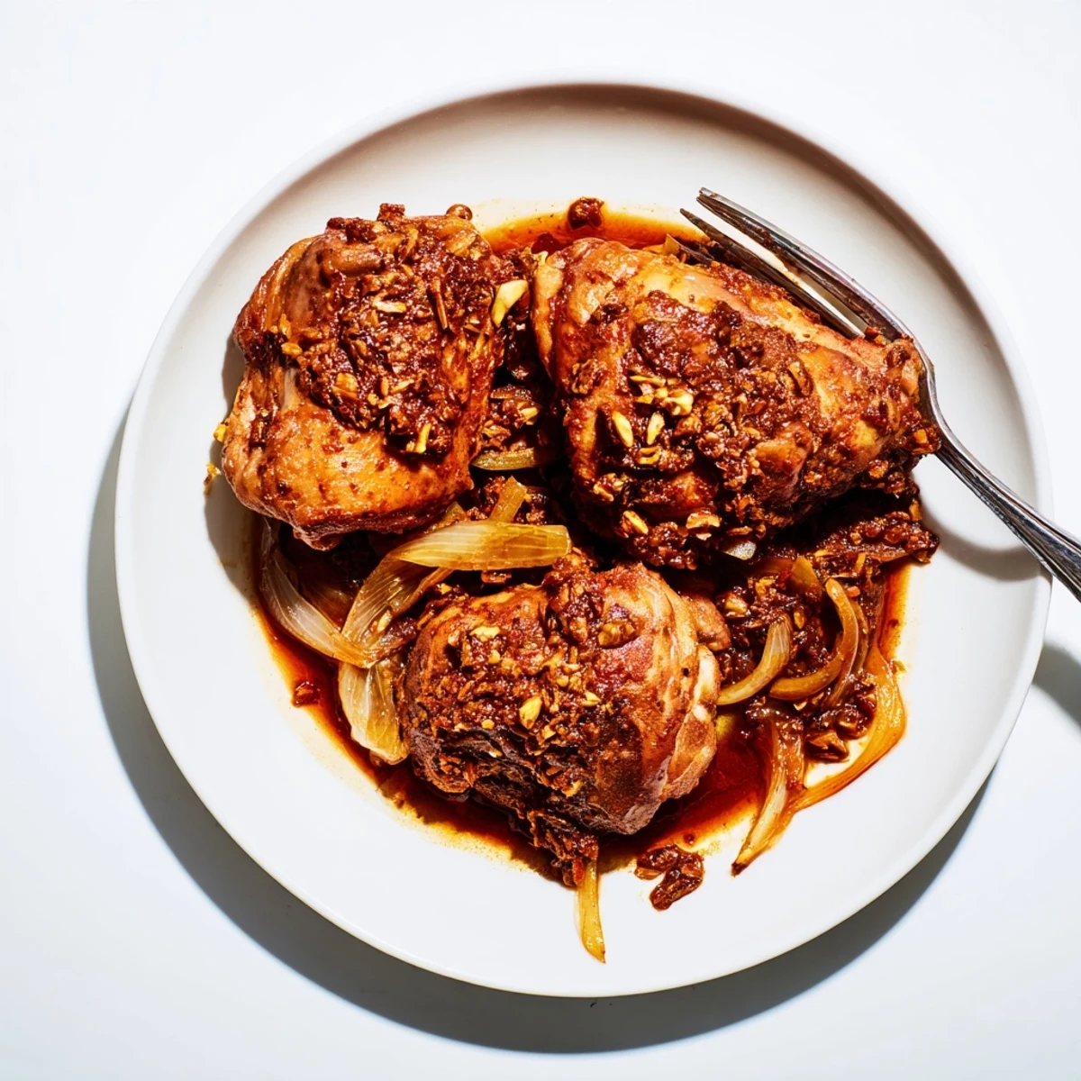 Delicious budget-friendly Fesenjan, served hot with fluffy rice, with a glimpse of the rich pomegranate sauce.