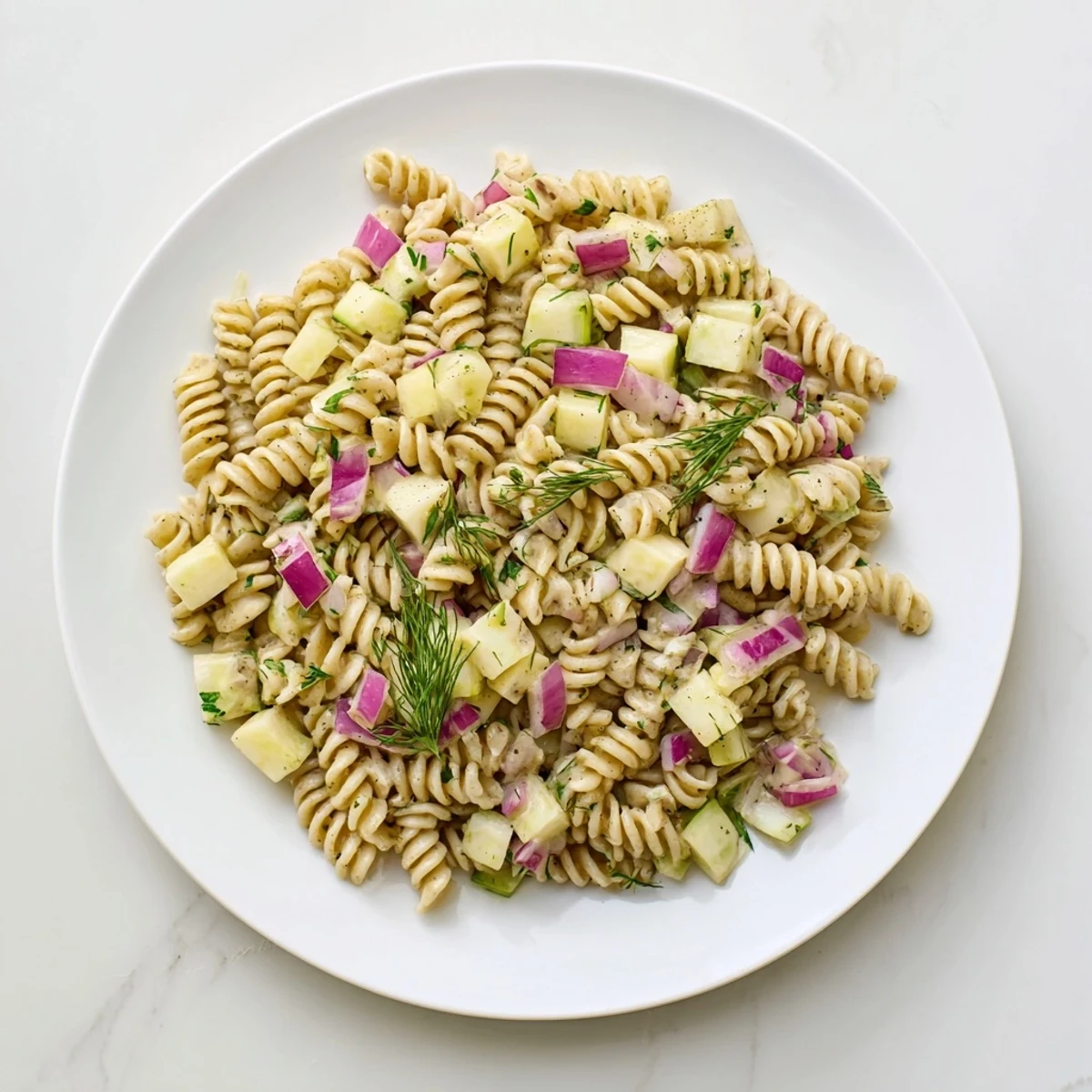 A delicious view of homemade dill pickle pasta salad ready for serving, chilled and flavorful.