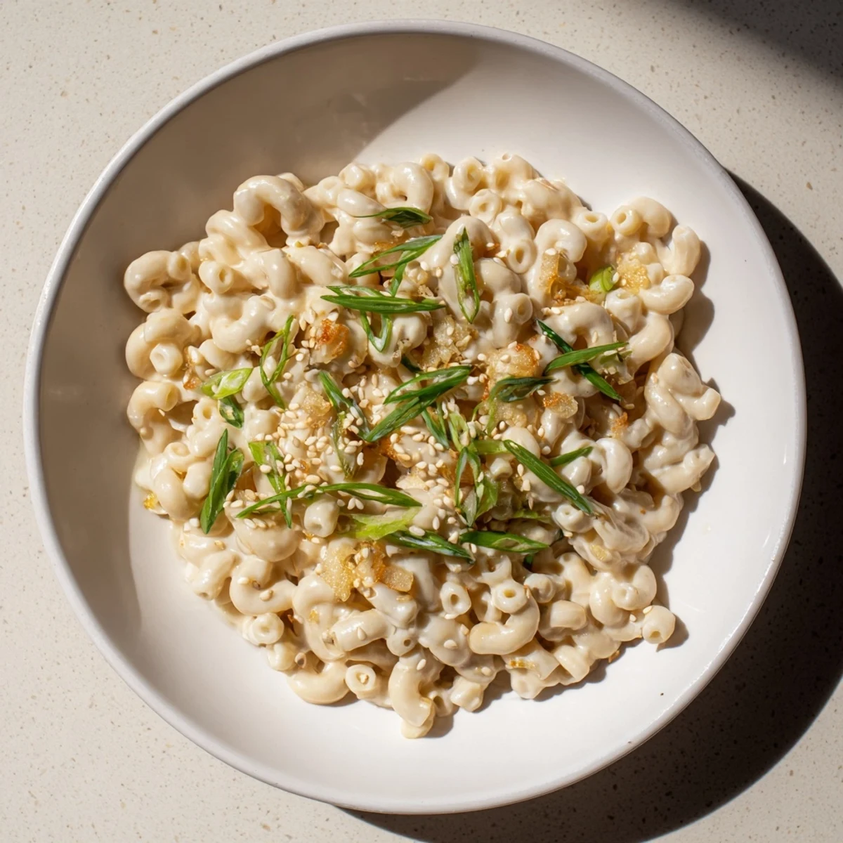 Warm creamy miso ditalini, a vegetarian pasta dish with rich miso flavor and scallion garnish.