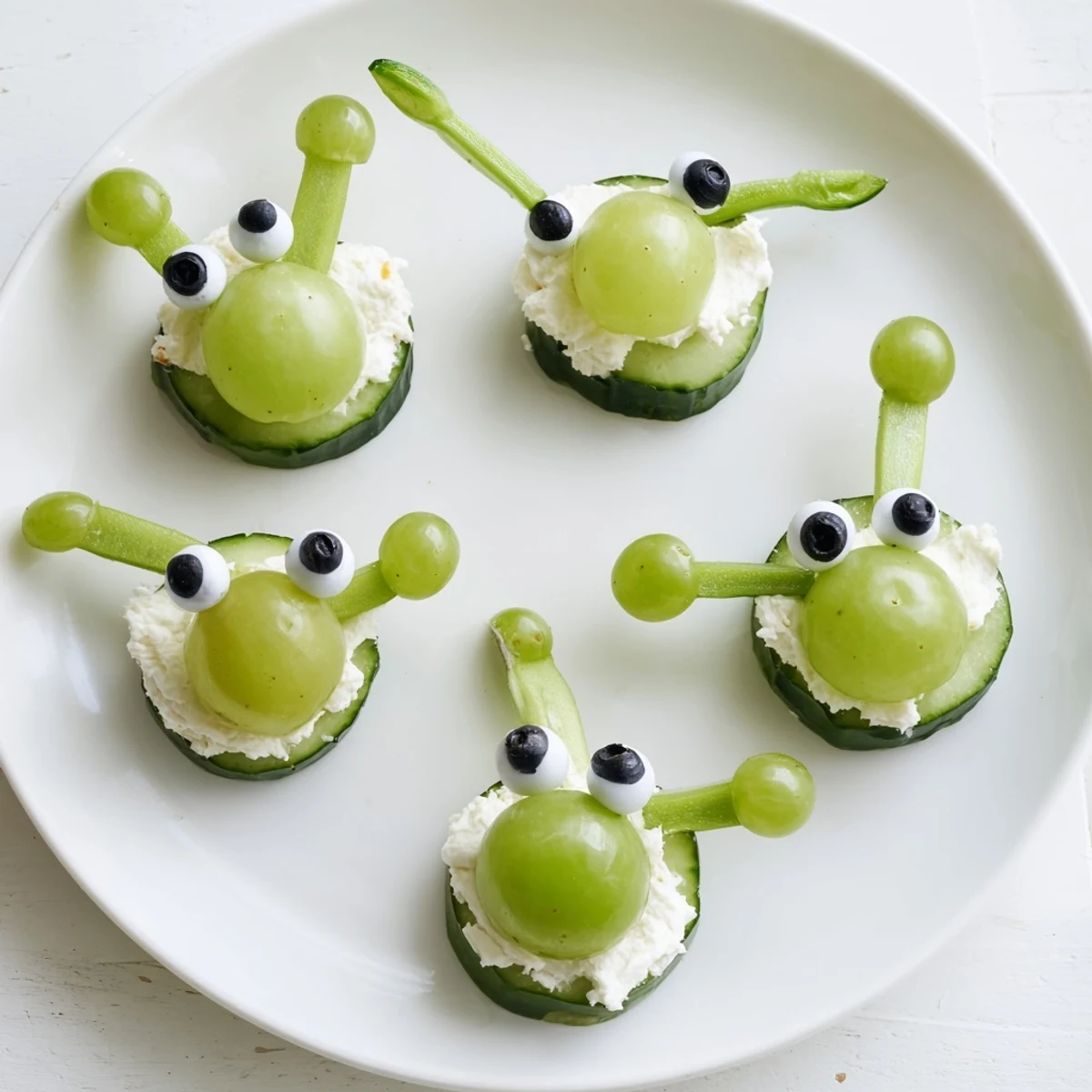 Vibrant Little Green Men Alien Snack Attack platter featuring cucumber alien faces and pretzel antennas.