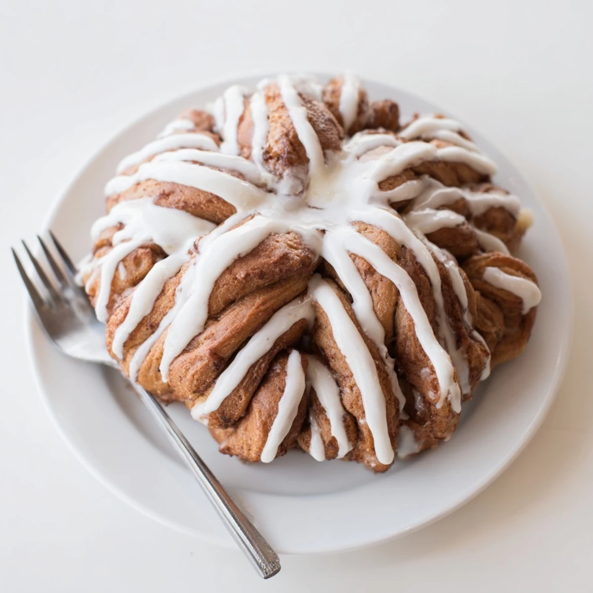 Aromatic cinnamon swirls within the Giant Snowflake Sweet Roll, glistening with sweet icing.