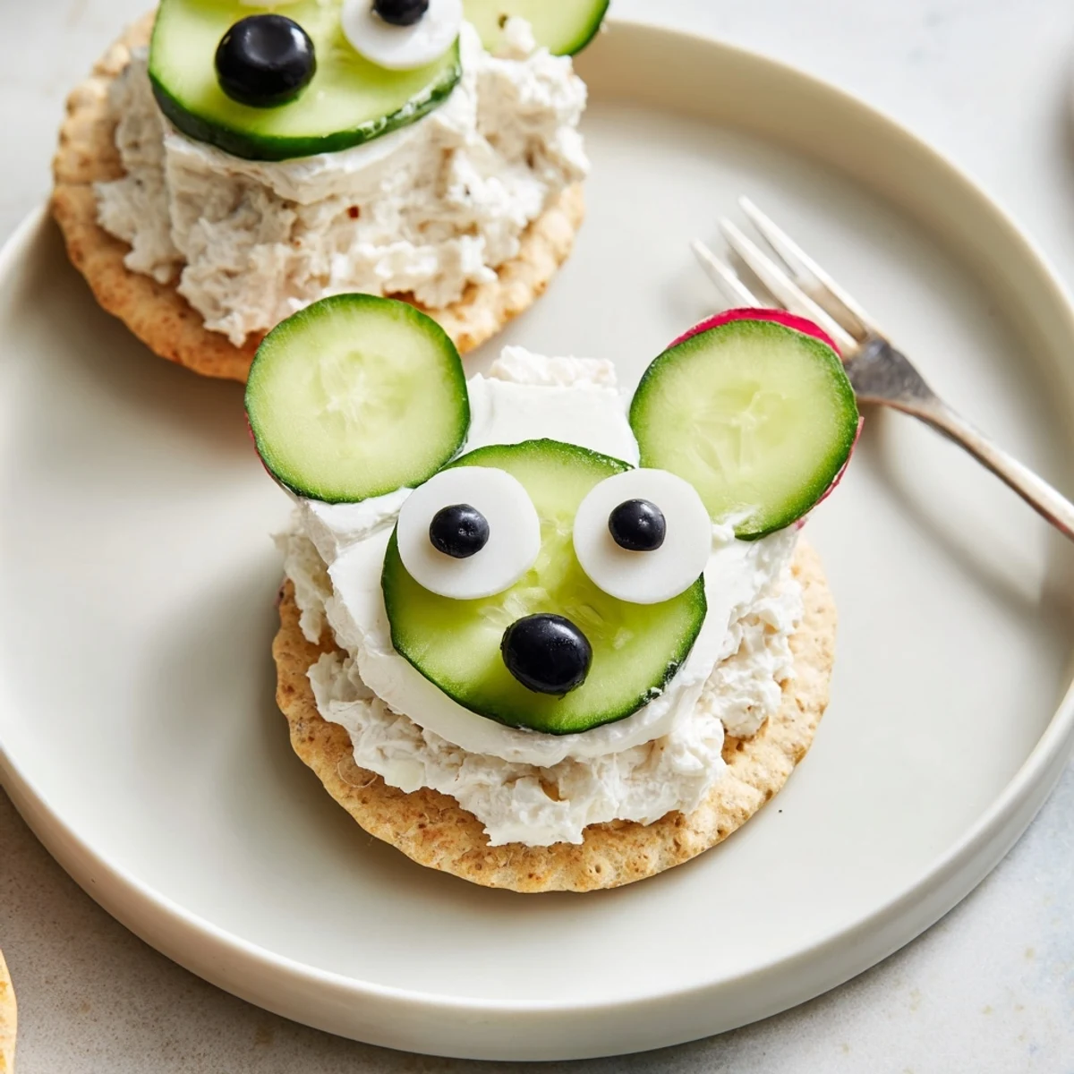Polar Bear Iceberg Cracker Stacks sit ready, featuring creamy cheese faces on cool cucumber ice.