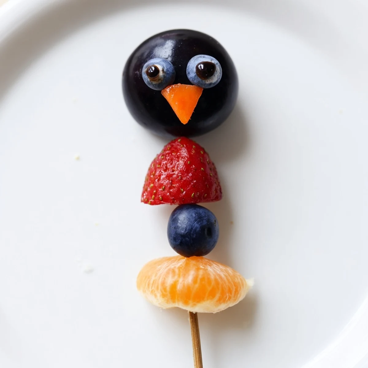 Vibrant Penguin Fruit Skewer Army featuring juicy grapes, strawberries, and blueberries, a fun snack for kids.