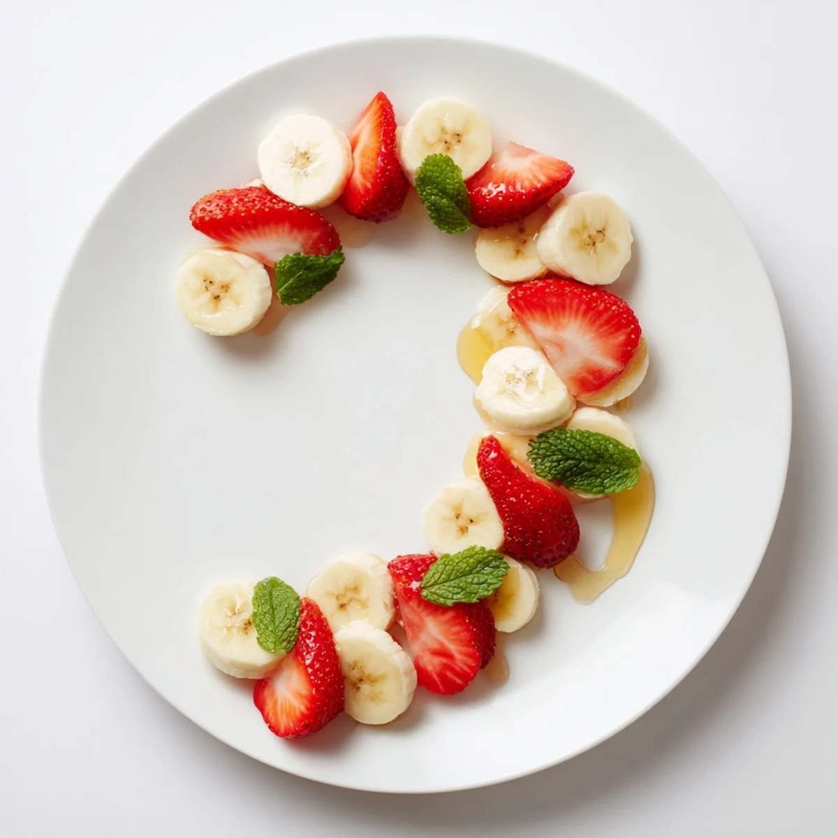 Vibrant banana strawberry candy cane snack, a festive treat with ripe fruit slices arranged playfully.