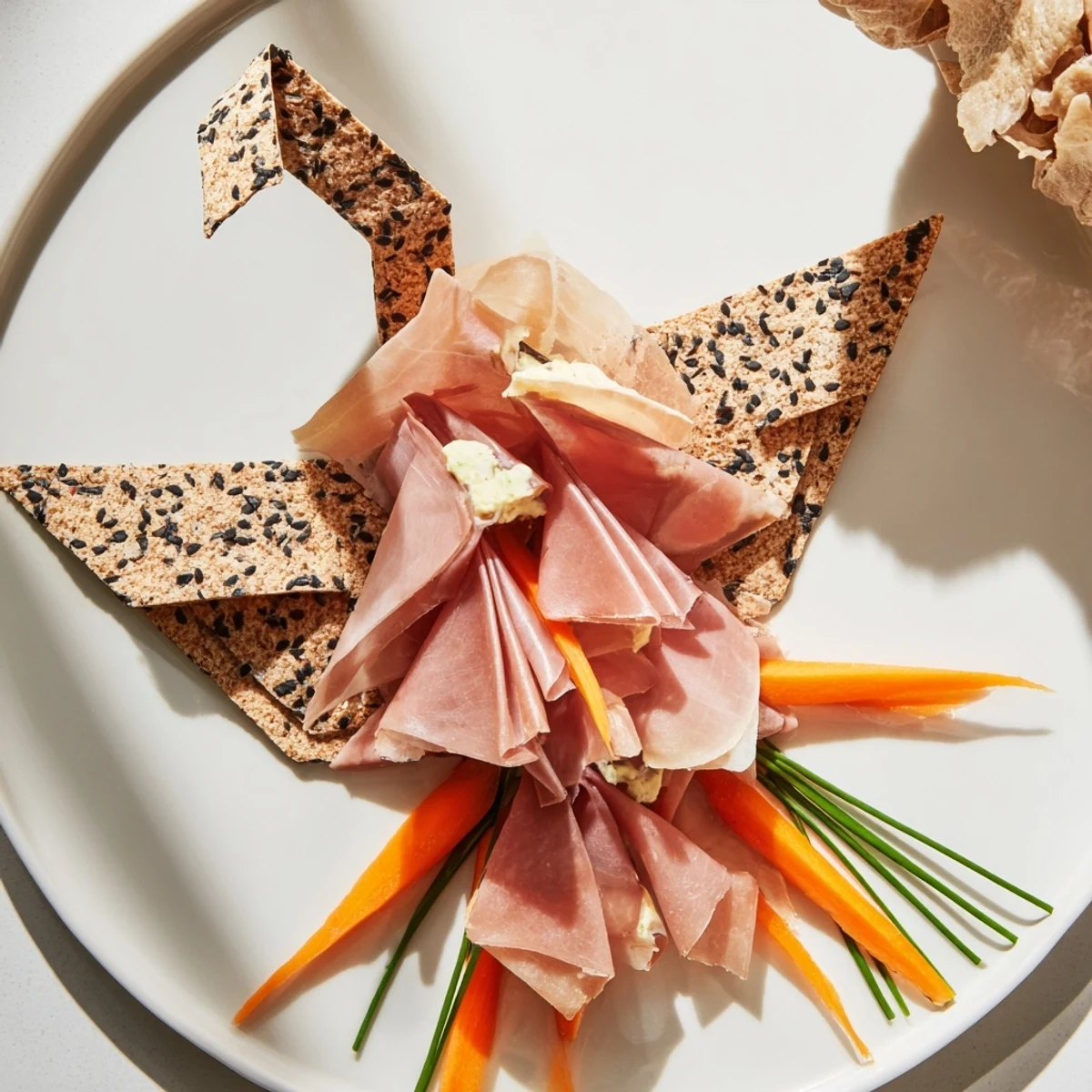 Delicate The Paper Crane appetizer featuring cured meats folded into elegant, edible art with crackers.