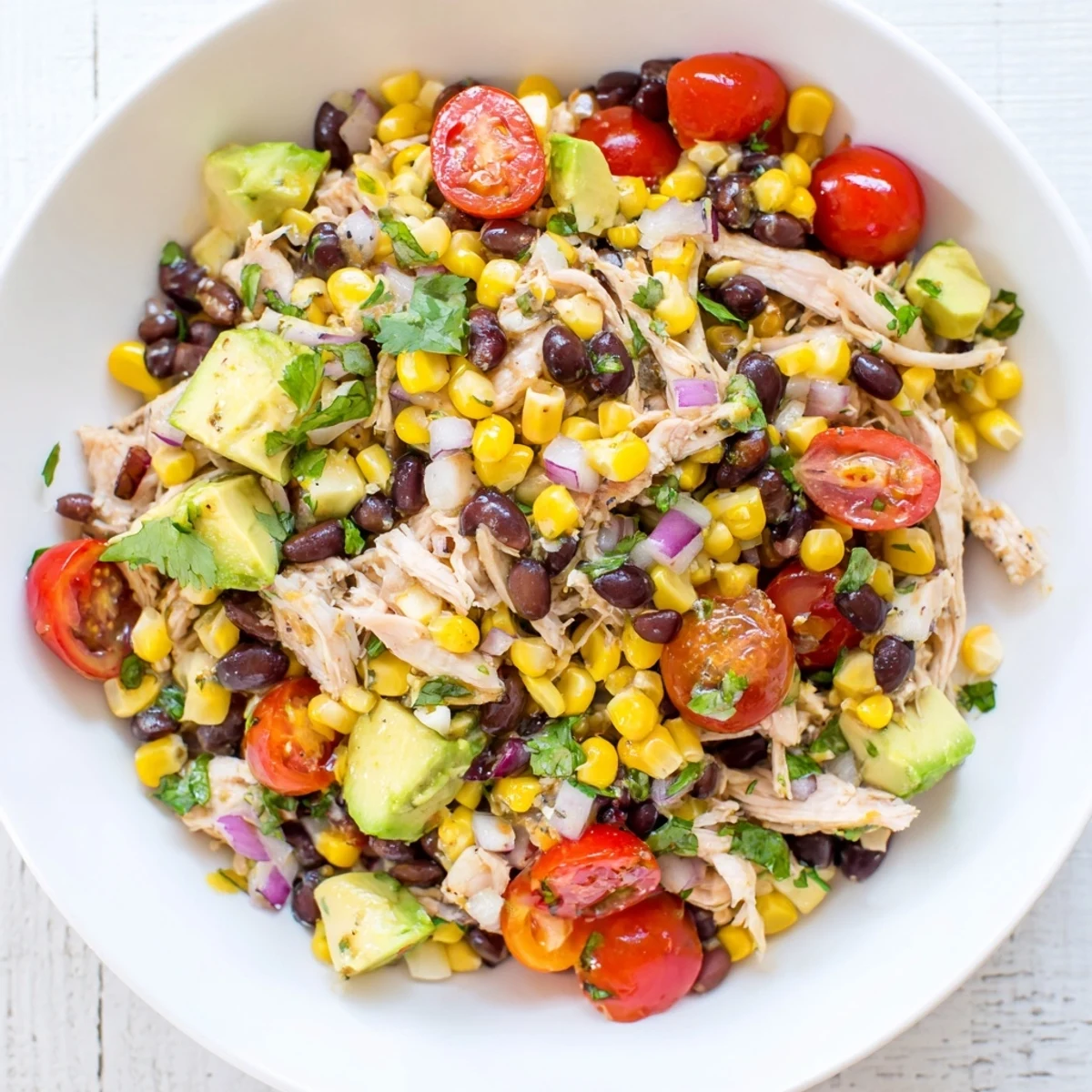 Close-up of vibrant Dense Southwestern Bean Salad, a flavorful, layered Tex-Mex side dish.