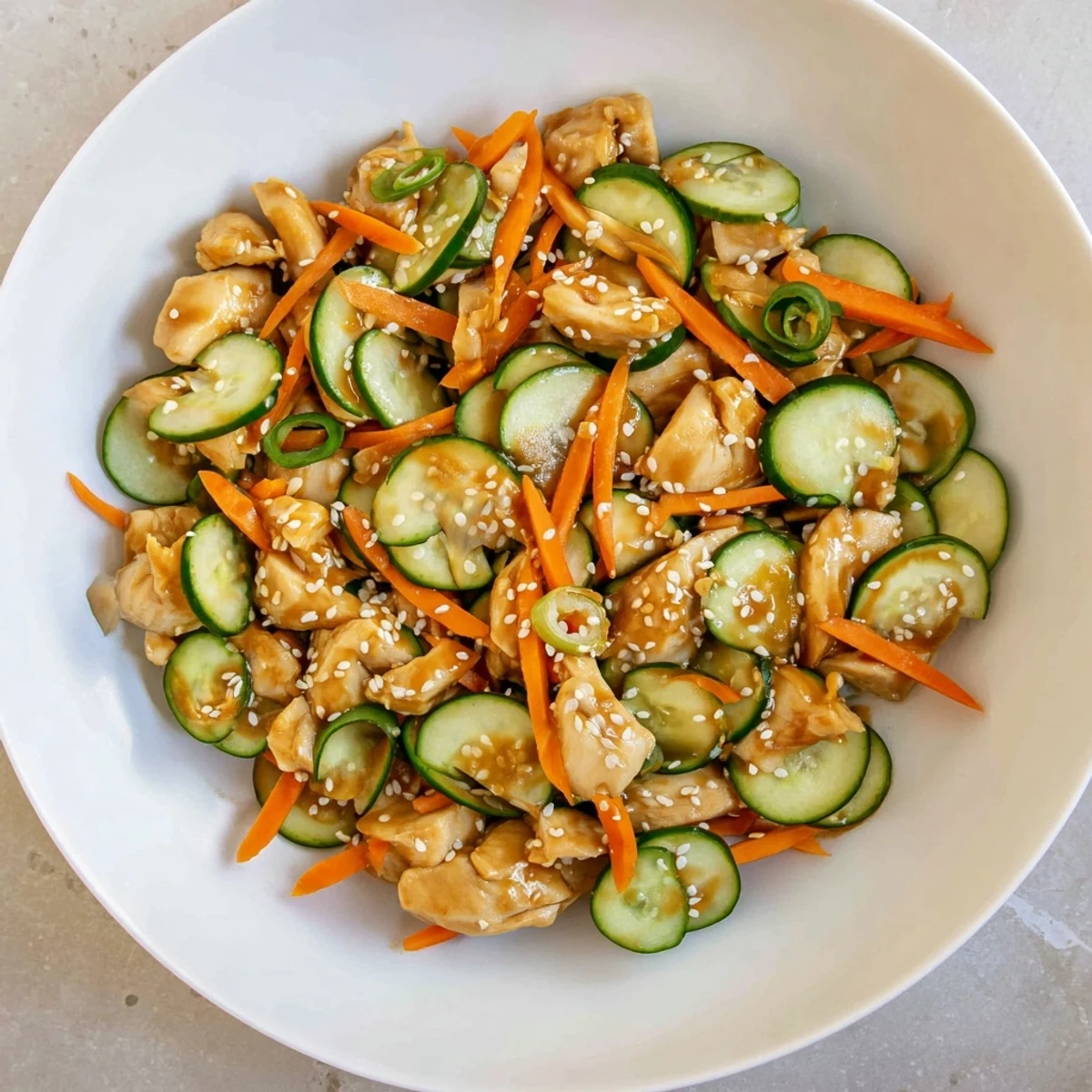 Vibrant photo of Deli Container Shaker Chicken Salad, showcasing flavorful ingredients like cucumber and scallions.