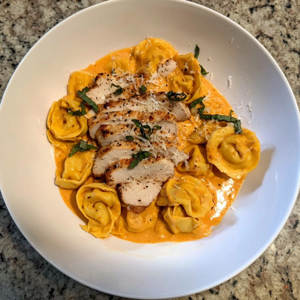 A steaming skillet of rich, flavorful Marry Me Chicken Tortellini, perfect for a cozy dinner.