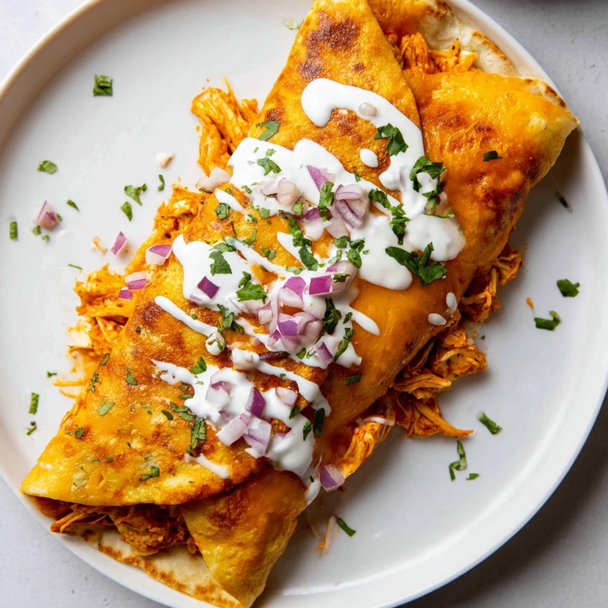 Delicious Buffalo Chicken Quesadilla, golden brown and cheesy, ready to be sliced and served with ranch.
