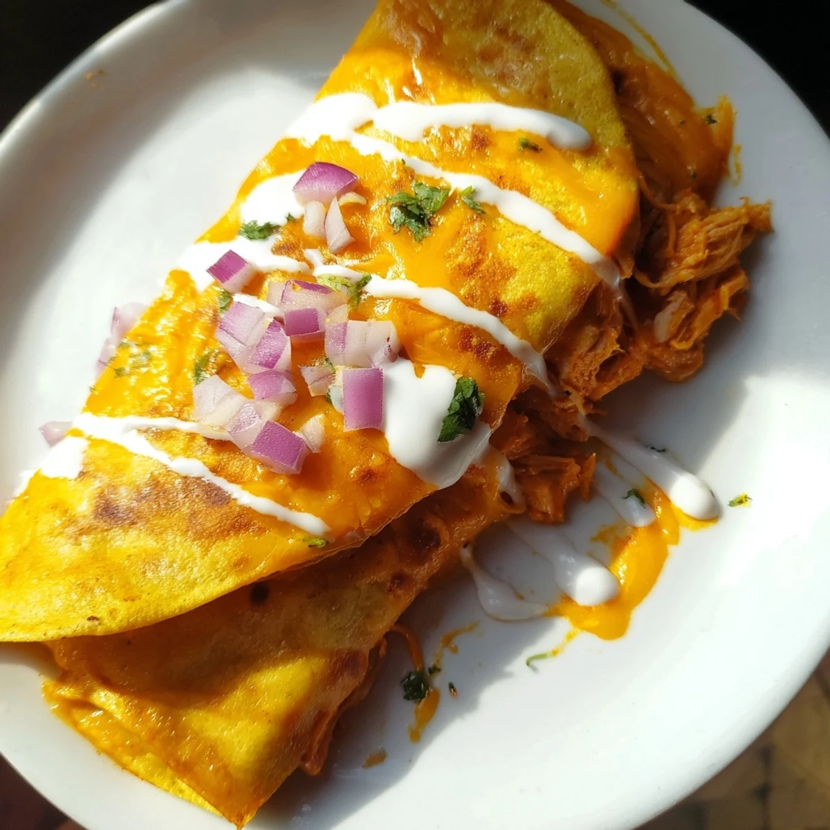 A close-up of a sizzling Buffalo Chicken Quesadilla, filled with melted cheese and spicy chicken.
