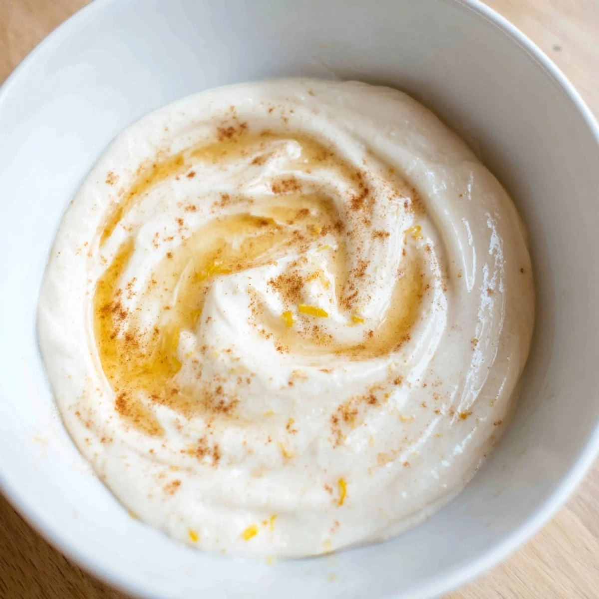 Creamy Greek yogurt fruit dip with fresh fruit like strawberries and melon, ready to serve.