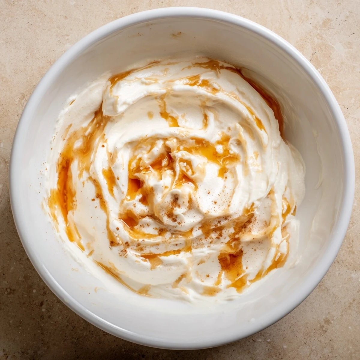 Tangy Greek yogurt fruit dip, swirled with honey, and served with a colorful fruit platter.