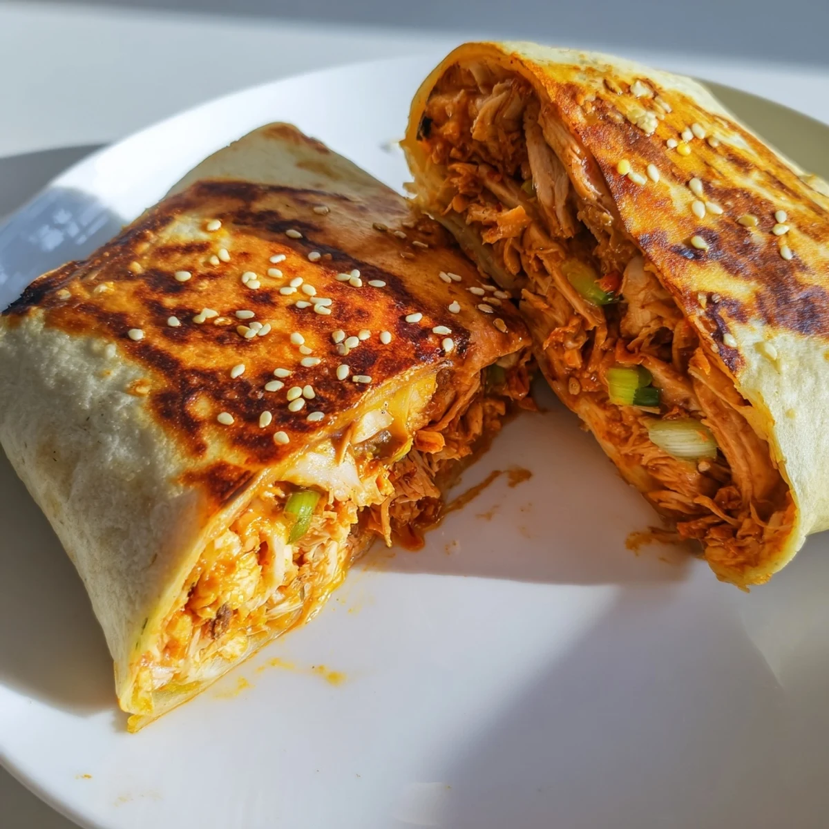 Golden-brown Korean BBQ Chicken Wrap Grilled Cheese, oozing melted cheese and savory chicken filling.