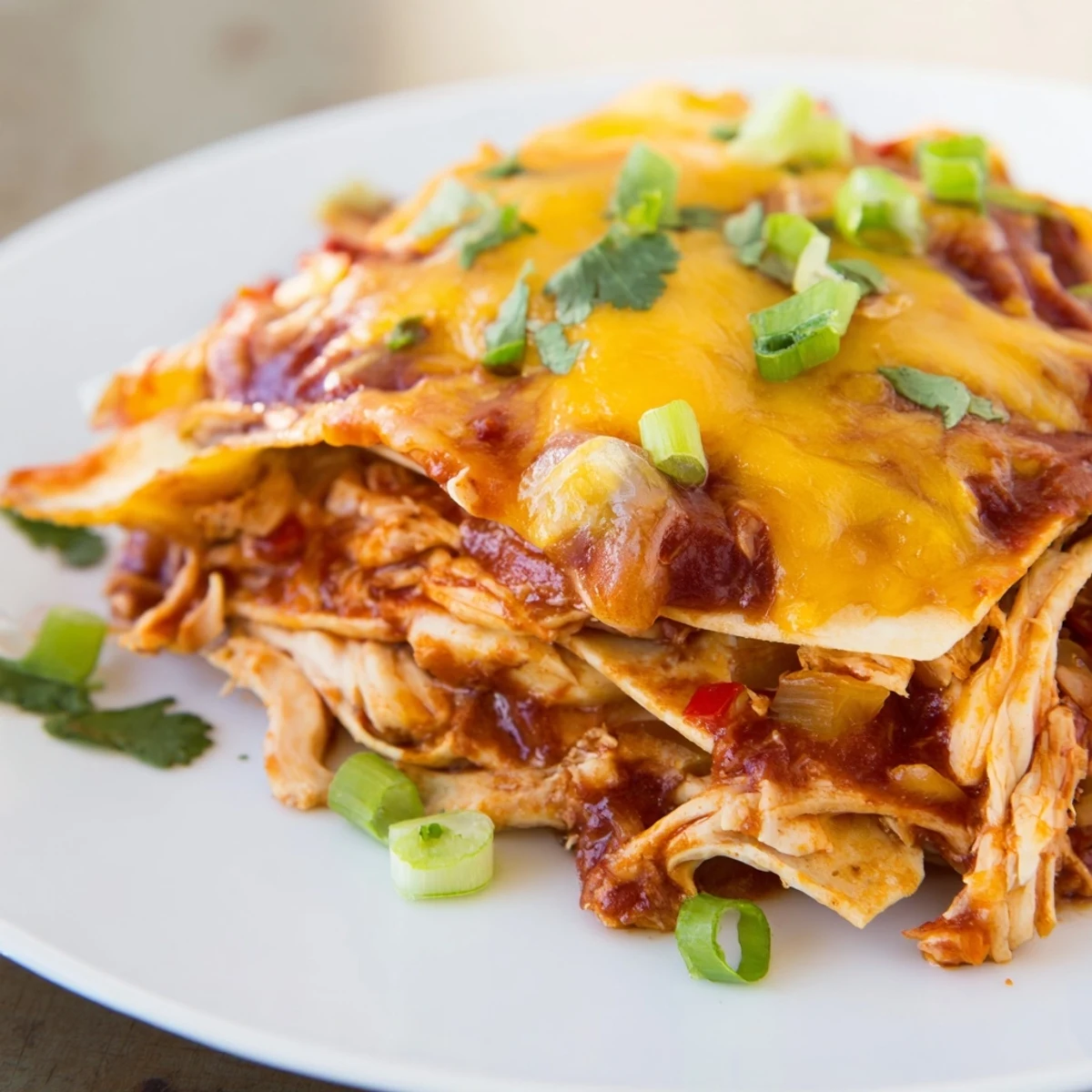 A bubbling, cheesy Chicken Enchilada Skillet with visible tortilla strips and flavorful, saucy ingredients.