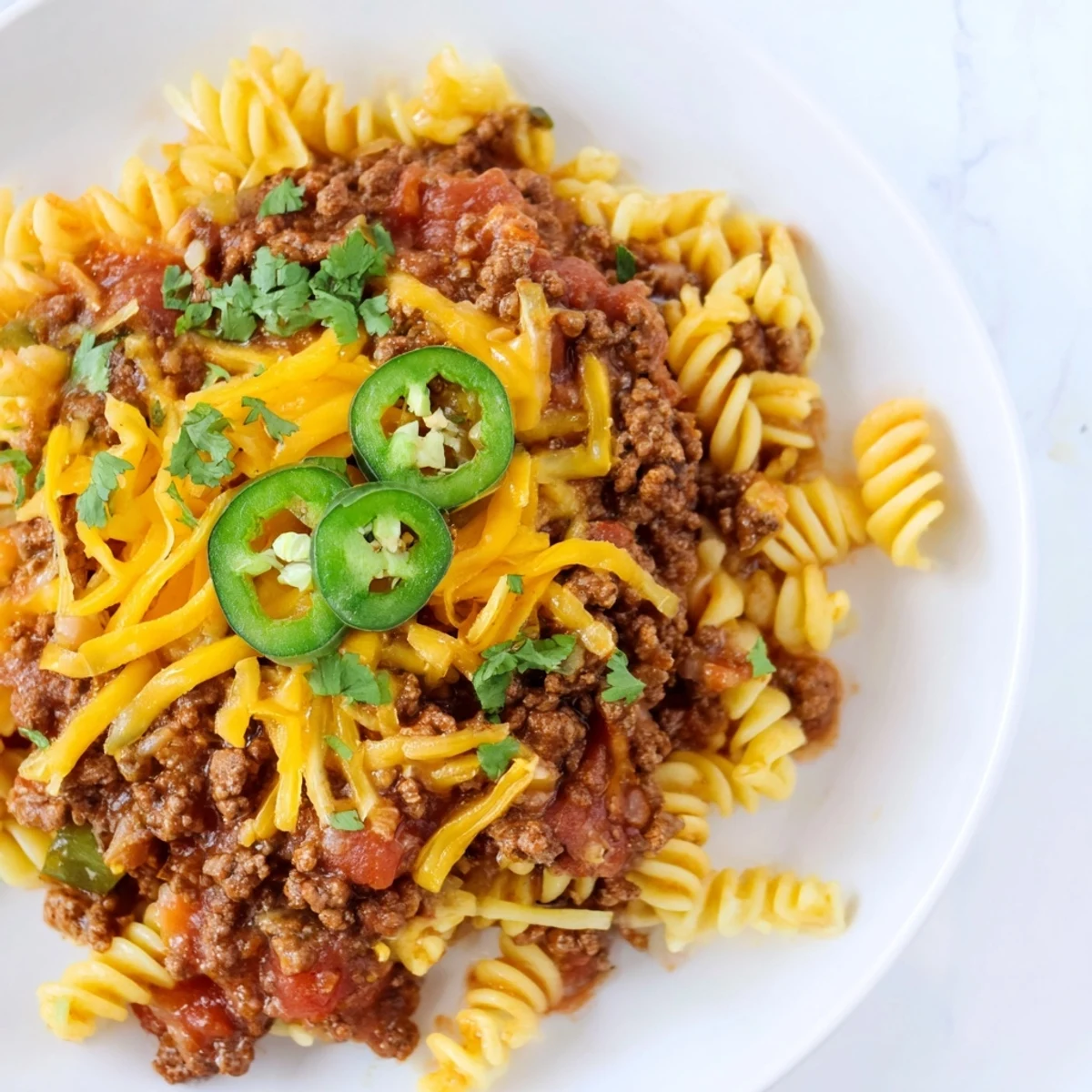 Steaming hot Beef Taco Pasta Skillet topped with melted cheddar, ready to be enjoyed.