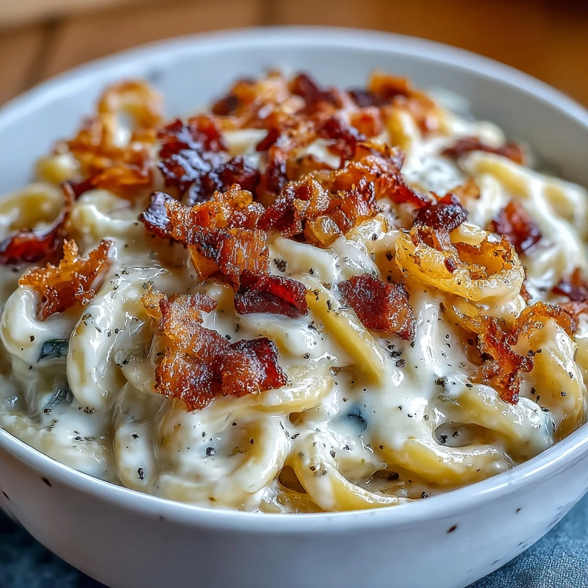 Close-up of Celeriac Carbonara with spiralized noodles, golden pancetta, and shaved Parmesan.