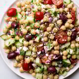 Freshly tossed Mediterranean Chickpea Salad with a vibrant lemon dressing, ready for serving or chilling.