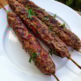 Deliciously spiced and grilled Iraqi Kebab Tikka kebabs, ready to enjoy with a squeeze of lemon and onion.