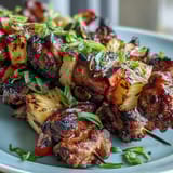 Grilled pineapple chicken skewers with juicy chicken and caramelized pineapple on skewers.
