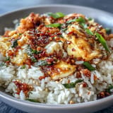 Fluffy jasmine rice tossed with scrambled eggs, chili crisp, and fresh scallions for a bold, savory Asian fusion meal.  