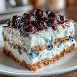 Tangy Lemon Blueberry Icebox Cake showcasing layers of tender graham crackers and fruit.