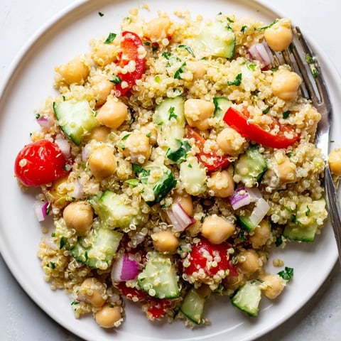 Colorful quinoa salad with chickpeas and creamy avocado dressing for a nutritious meal.  