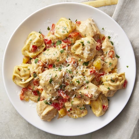 Steaming hot Zesty Cajun Garlic Parmesan Chicken Tortellini, a creamy, cheesy pasta dish with chicken.