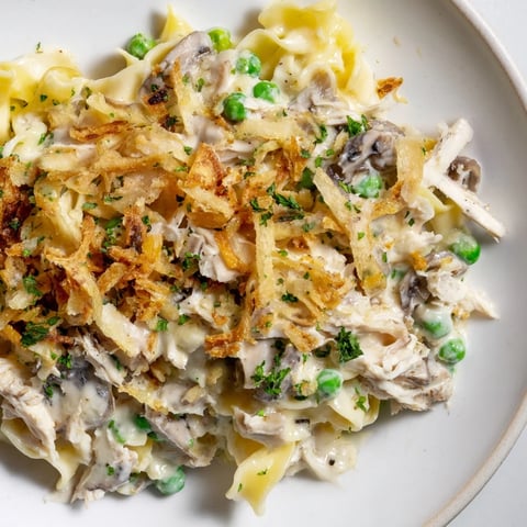 Golden, bubbly Tuna Noodle Casserole with a crispy onion topping, perfect for weeknight dinners.