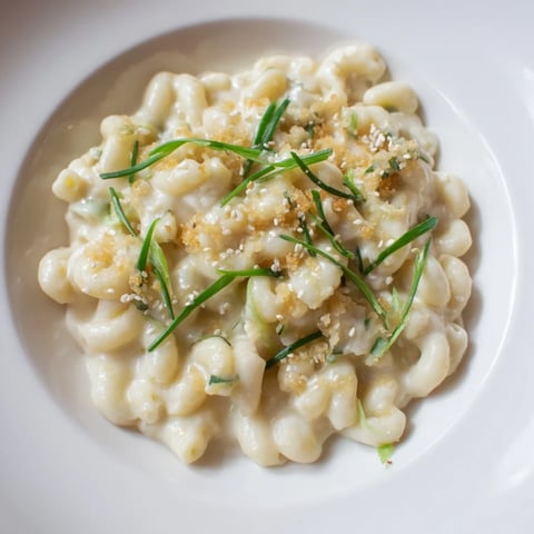 Creamy miso ditalini, a beautiful bowl of pasta with sesame seeds and green scallions.