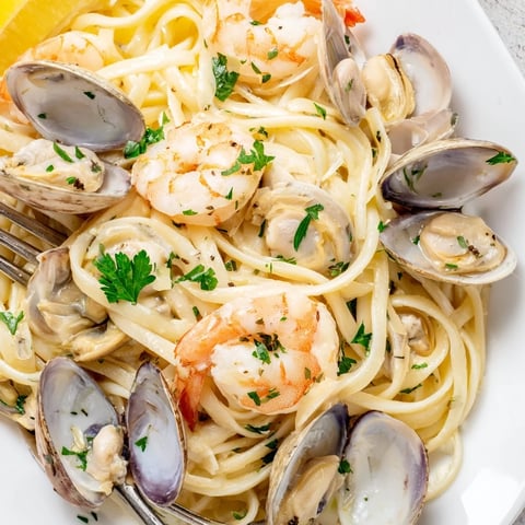 Plump, pink shrimp and open-shelled mussels nestle in a heaping bowl of Seafood Linguine, glistening with a fragrant white wine garlic sauce.