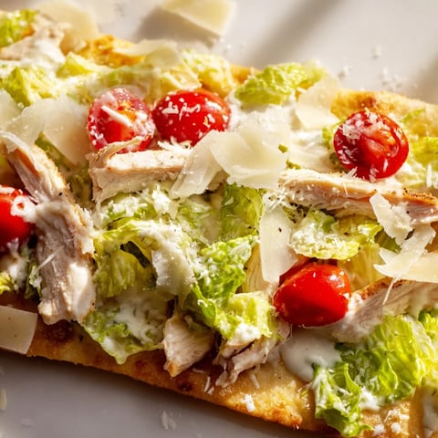 Golden, crispy flatbread loaded with grilled chicken slices, fresh romaine, and creamy Caesar dressing.  