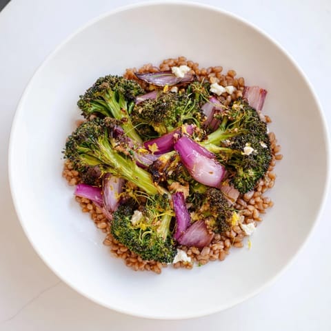 Golden roasted broccoli and red onion mingle with nutty farro in this healthy recipe.