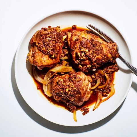 Delicious budget-friendly Fesenjan, served hot with fluffy rice, with a glimpse of the rich pomegranate sauce.