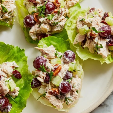 Close-up of fresh, flavorful Simplified Festive Chicken Salad Cups with grapes and pecans.
