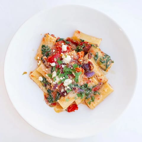 Creamy feta tops the flavorful Mediterranean Baked Garlic & Herb Pasta, a vegetarian delight, perfectly baked.