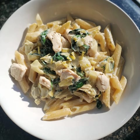 Savory Creamy Spinach Artichoke Protein Pasta Skillet, ready to eat with spinach and artichokes.