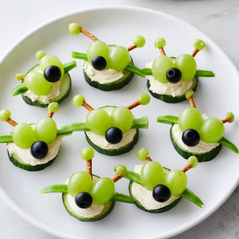 Playful Little Green Men Alien Snack Attack: Fresh veggie aliens with grapes and edible candy eyes, ready to eat!