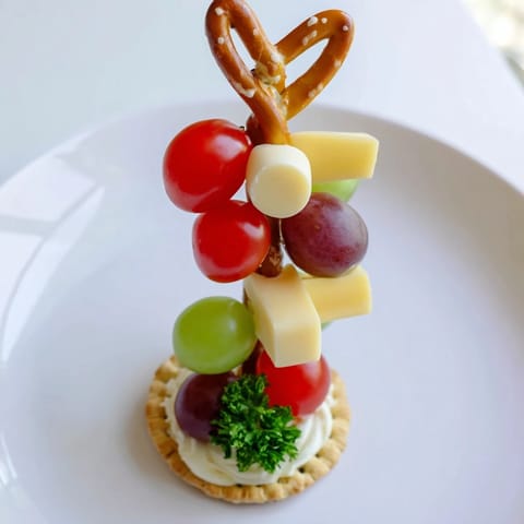 These playful Up, Up, & Away Hot Air Balloon Snacks are ready, with grapes and cheese atop tiny crackers.