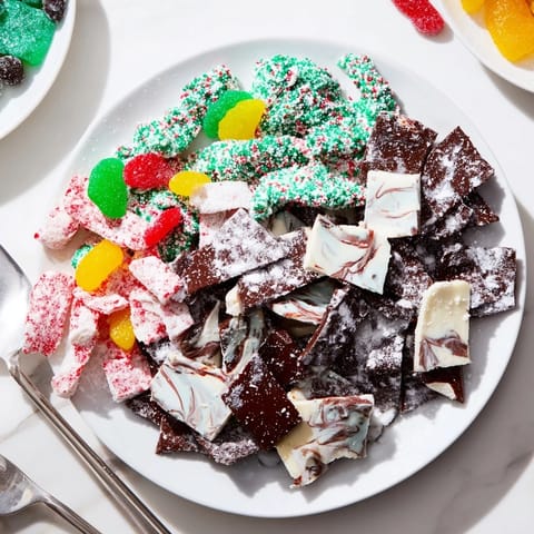 A dazzling close-up showing vibrant, homemade Jingle Bell Rock Candy arranged with other sweet treats this holiday.
