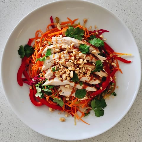 Imagine juicy chicken slices atop crisp veggies with the tasty, unique Ginger-Miso dressing of this Chicken Slaw.