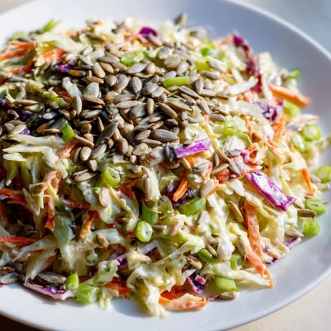 This homemade crunchy coleslaw salad boasts shredded cabbage, carrots, and a creamy dressing, ready to enjoy.