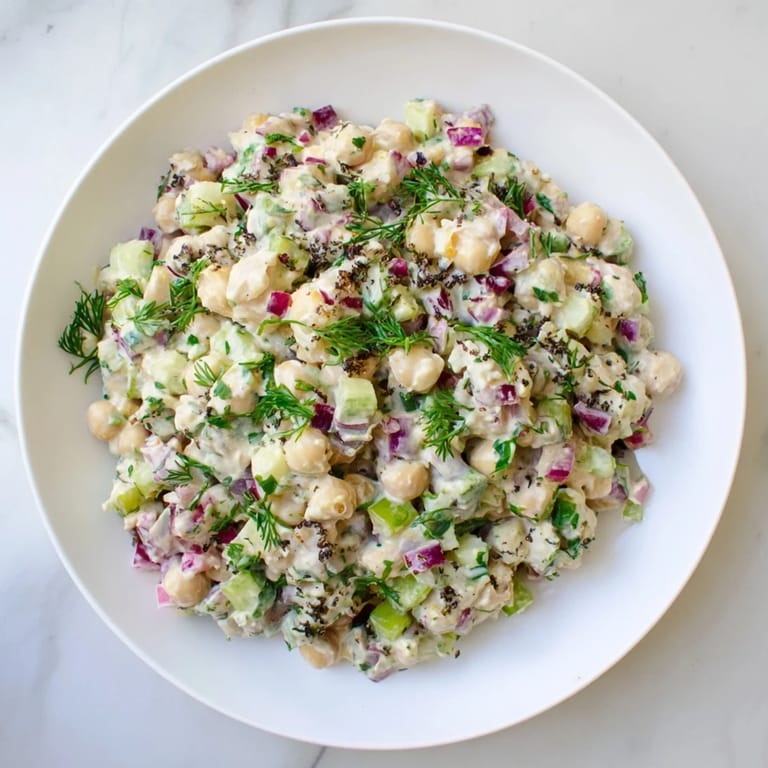 Chunky chickpea tuna salad with visible celery and red onion, tossed in creamy dressing.