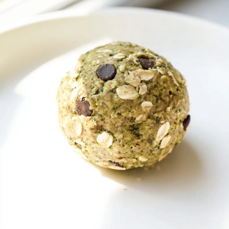 Close-up of freshly made Matcha Gingerbread Cookie Dough Protein Bites, showcasing a delightful texture and color.