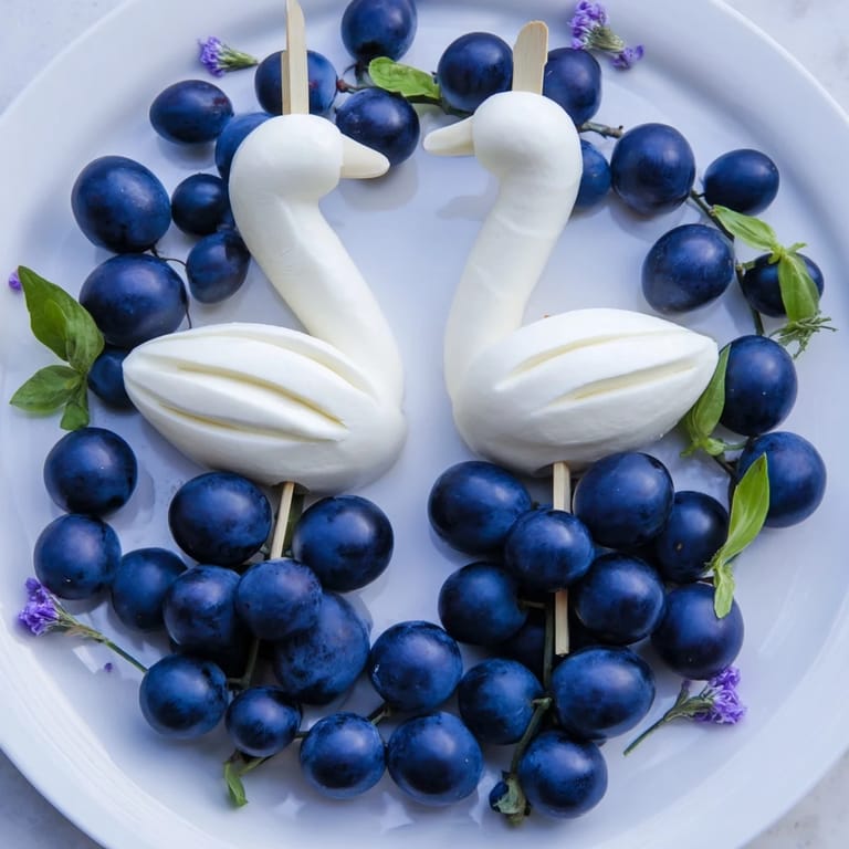 Elegant Swan Lake Board: Serene cheese and grape arrangement, featuring swan shapes for appetizer elegance.
