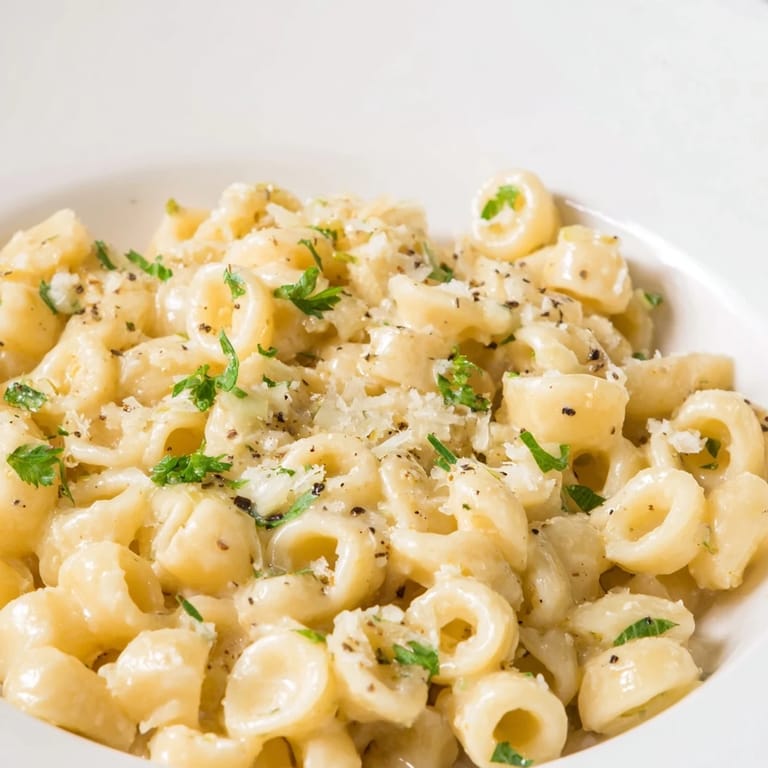 Tempting view of creamy 15-Minute Creamy Garlic Butter Ditalini, ready to serve with Parmesan.