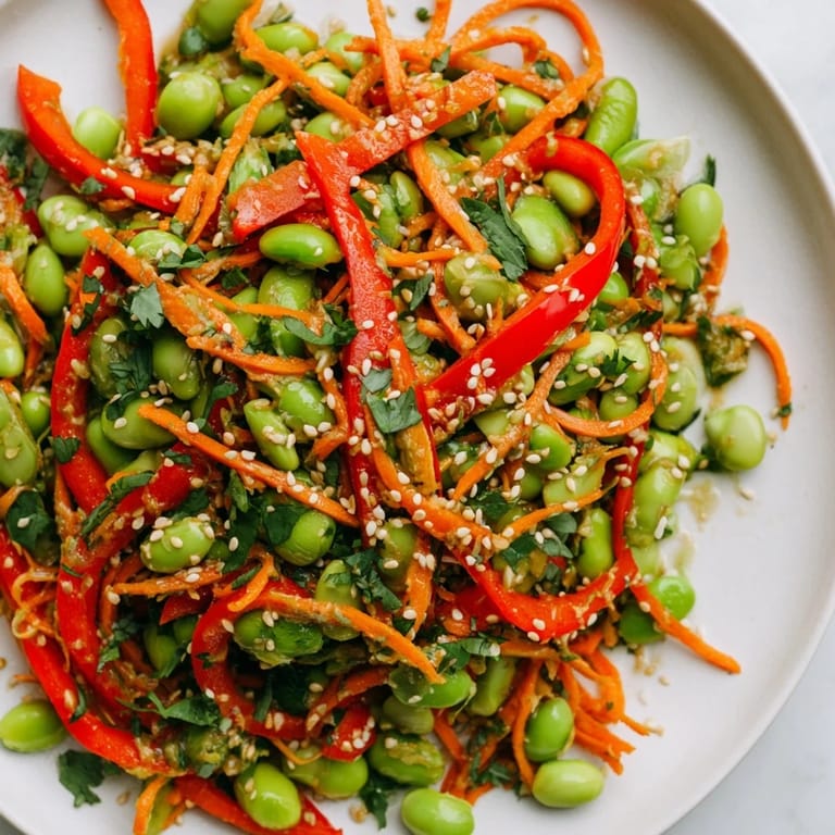 Bright green edamame in a delicious Asian Edamame Salad, coated in flavorful sesame ginger dressing.